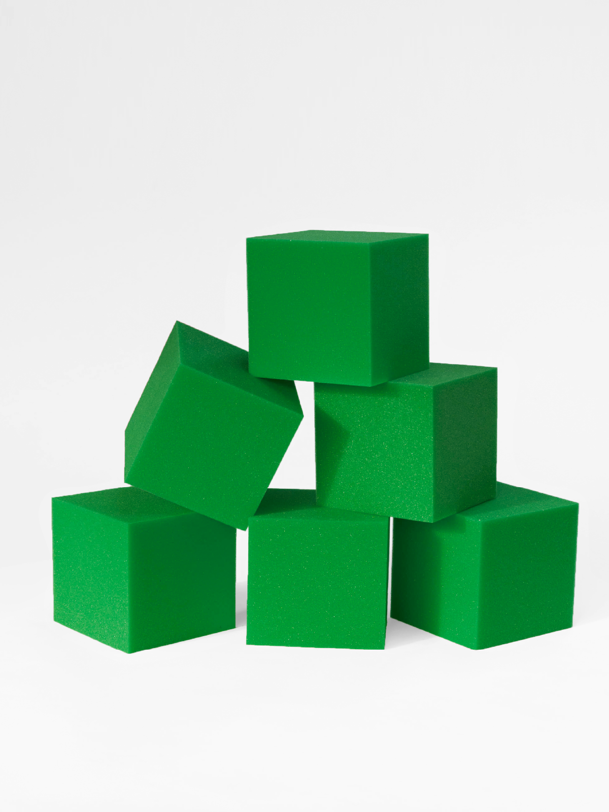 Stack of green foam blocks on a white background