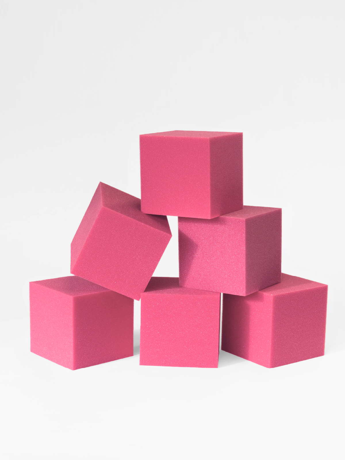 Stack of pink foam cubes on a white background